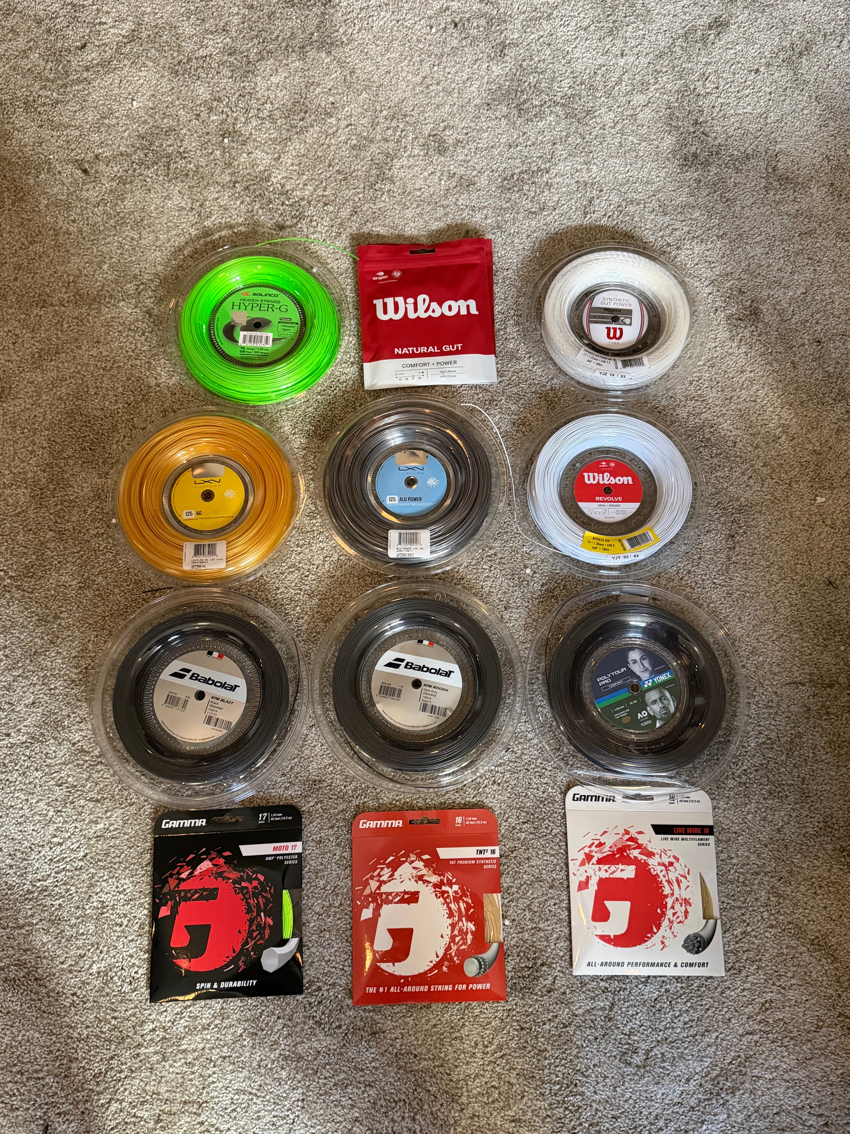 String inventory — Wilson, Babolat, Yonex, and Gamma reels and sets