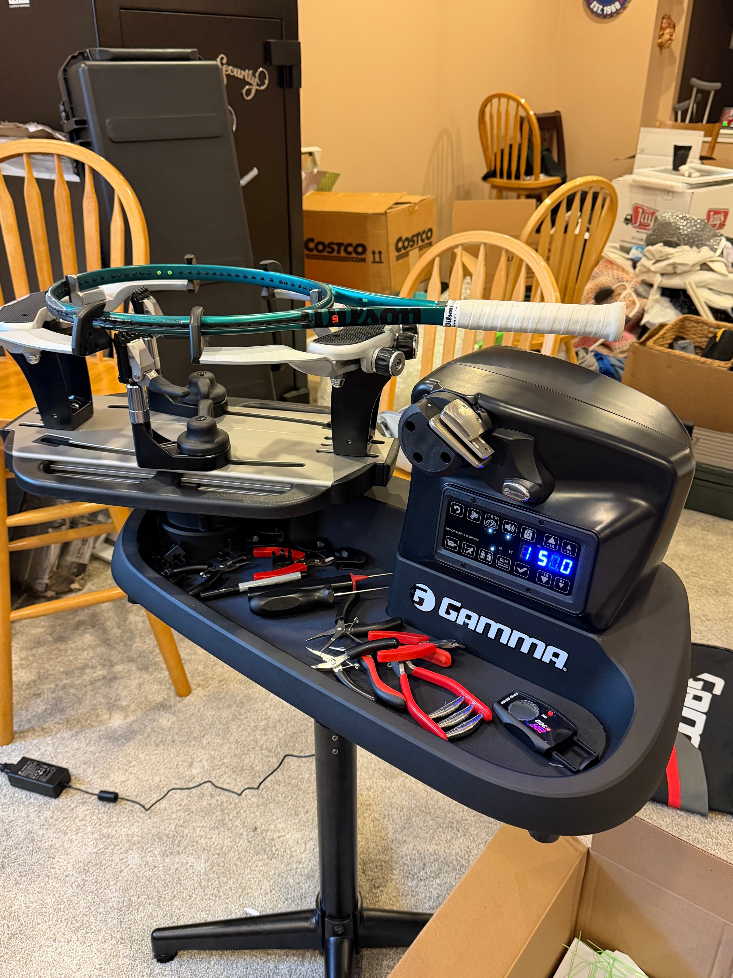 Gamma stringing machine in action with racket mounted