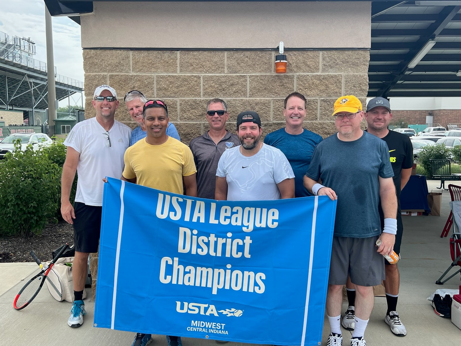 USTA League District Champions — team photo with banner
